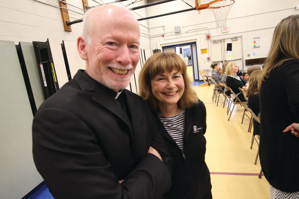 SHANLEY TEAM: Norwood teacher Patti Shanley and Father Brian Shanley, former president of Providence College and the twin brother of Patti’s late husband, Paul, share a moment Monday during Coach Cooley’s visit.